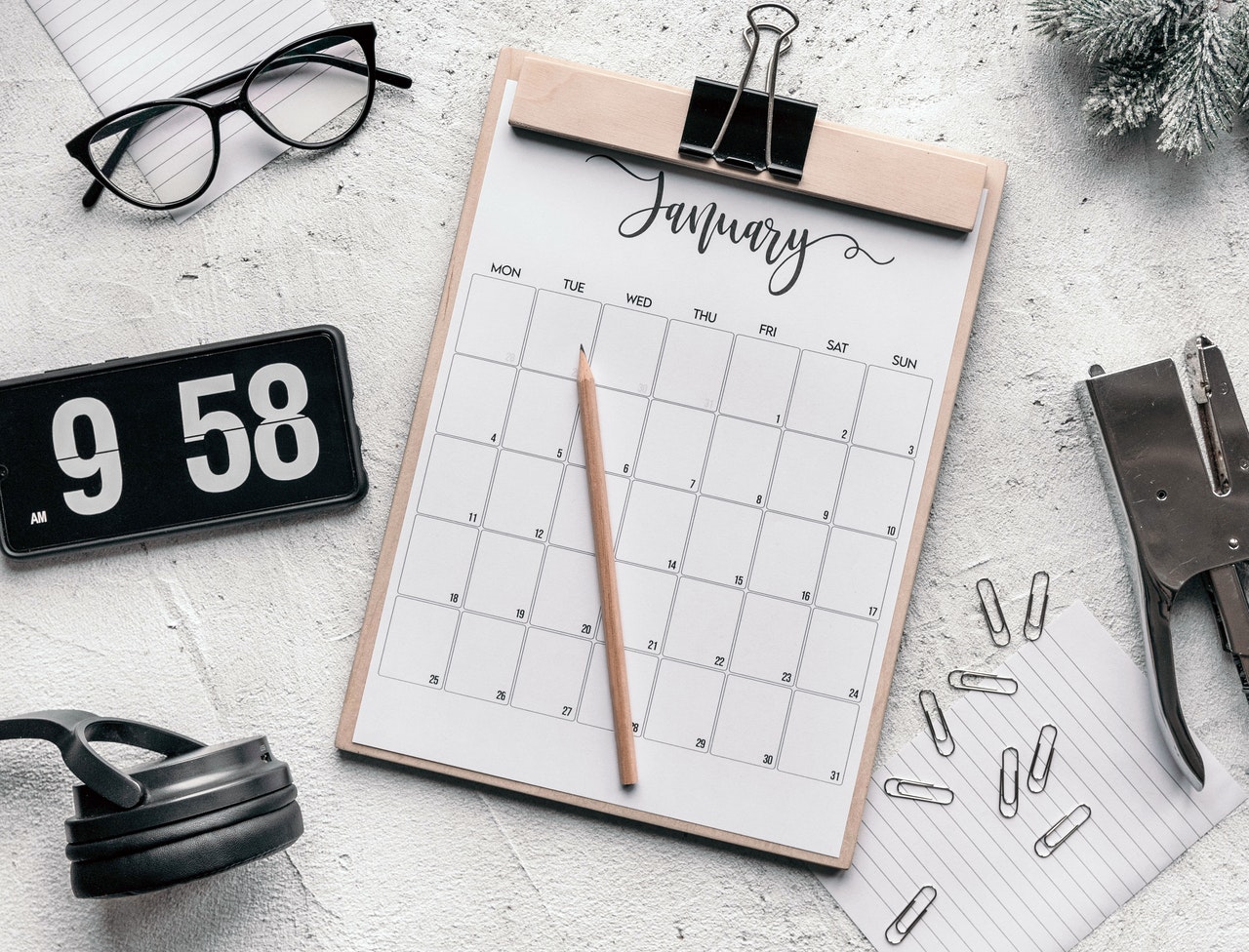 Busy desk showing January calendar - how much time do estate agents spend writing property listing copy?